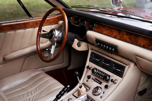 Interior of a classic car with leather seats and steering wheel