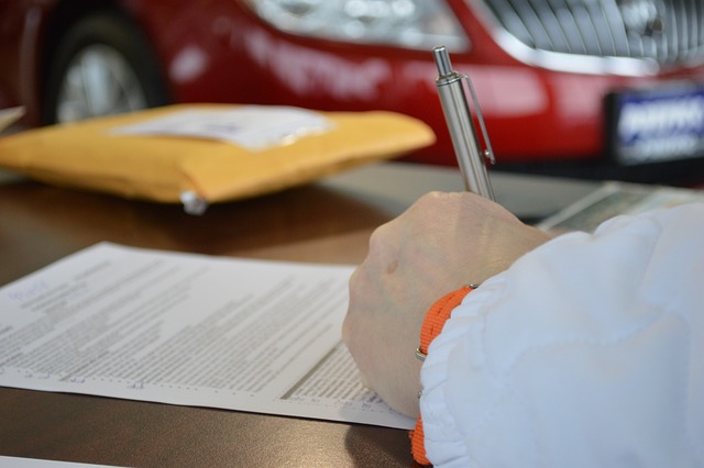 Person signing contract for dispensary license with pen and paper