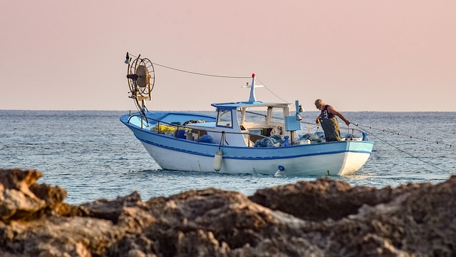 A man standing on a boat in the ocean