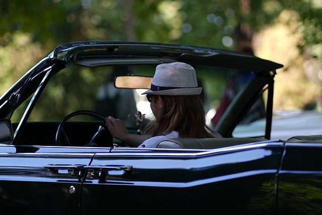 A woman driving a classic car on a sunny day, lost her driver's license in Ohio